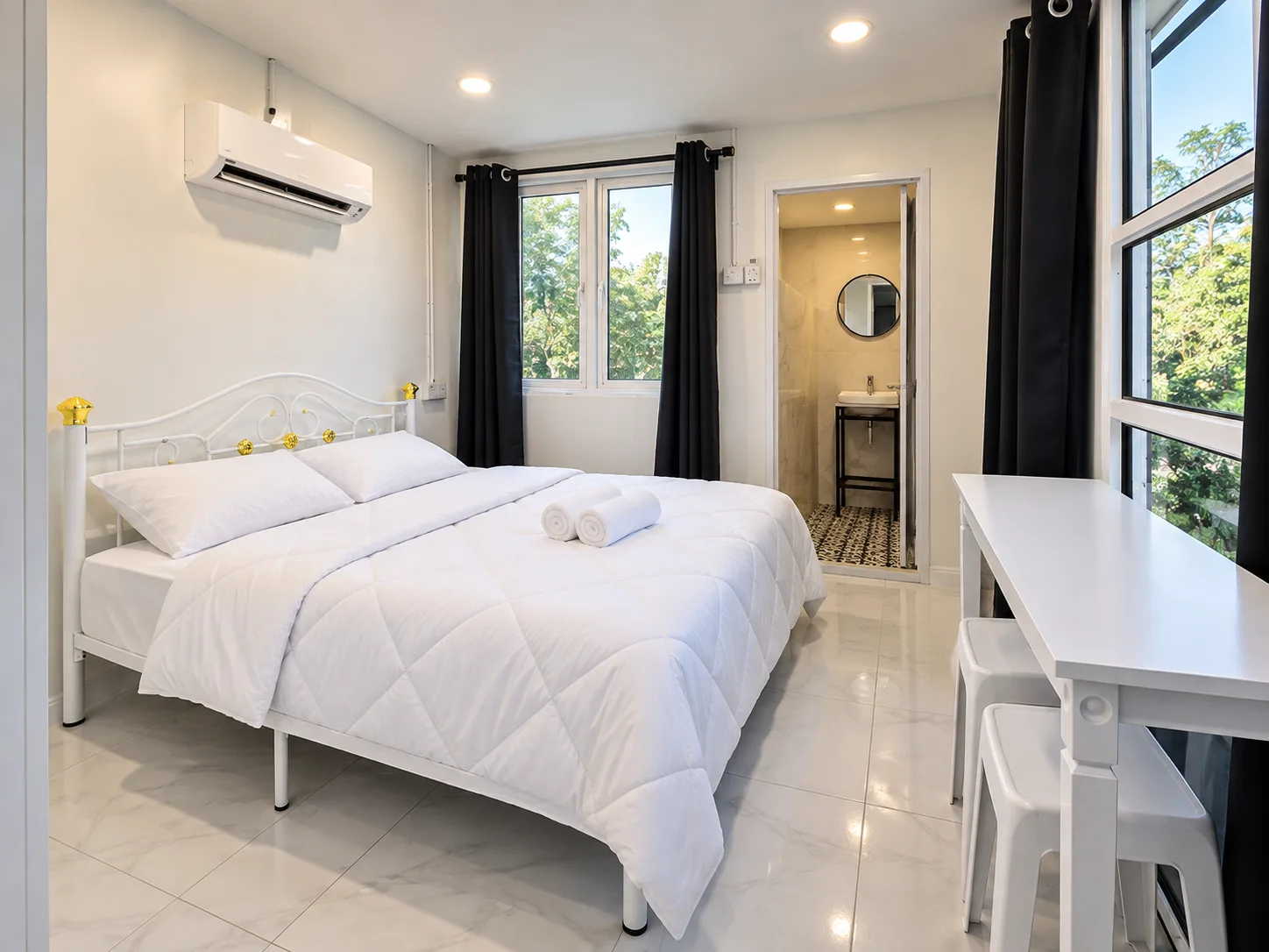 A bright white Sentosa Palace room with black curtains